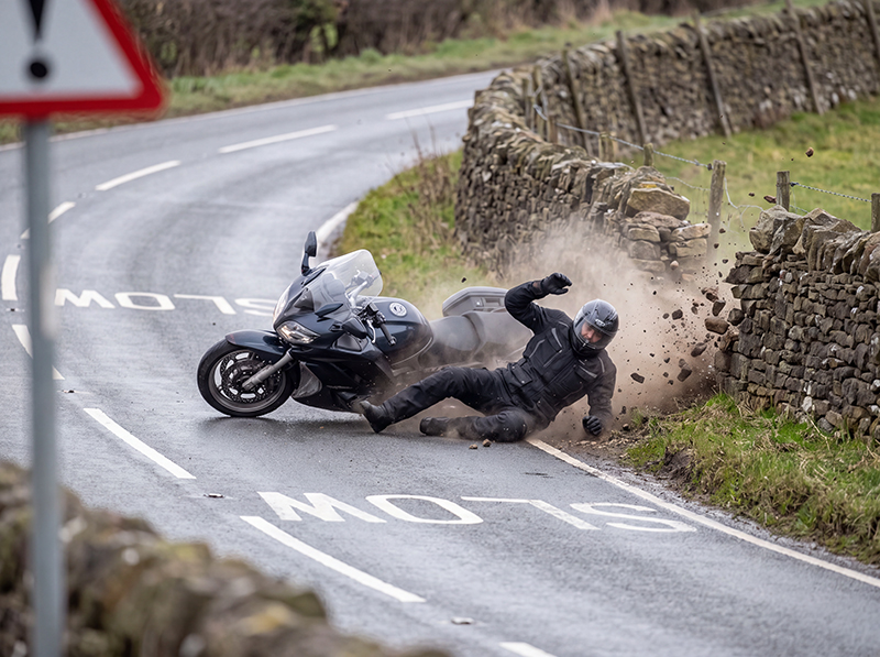 Motorcyclist hitting stone wall